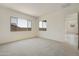 Spacious bedroom with carpeted flooring, bright natural light, and an ensuite bathroom access at 5533 N 193Rd Ave, Litchfield Park, AZ 85340