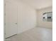Neutral bedroom features light-colored walls, a window, and a paneled door at 5533 N 193Rd Ave, Litchfield Park, AZ 85340