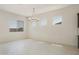 Open dining area boasts sleek chandelier, large windows, and access to kitchen at 5533 N 193Rd Ave, Litchfield Park, AZ 85340