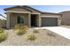 Charming single-story home with a gray two-car garage and low-maintenance desert landscaping at 5533 N 193Rd Ave, Litchfield Park, AZ 85340