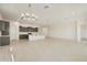 Spacious kitchen with stainless steel appliances, a large island, and a modern chandelier at 5533 N 193Rd Ave, Litchfield Park, AZ 85340