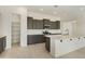 Well-equipped kitchen with gray cabinetry, quartz countertops, and a walk-in pantry at 5533 N 193Rd Ave, Litchfield Park, AZ 85340