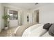 Bright main bedroom featuring neutral tones, a large window, and ensuite bathroom access at 5533 N 193Rd Ave, Litchfield Park, AZ 85340