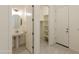 Contemporary powder room with a decorative mirror, pedestal sink, and access to storage space at 5533 N 193Rd Ave, Litchfield Park, AZ 85340