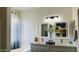 Elegant bathroom featuring a double vanity, modern fixtures, and a soaking tub at 6421 S 23Rd Dr, Phoenix, AZ 85041