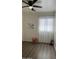 Clean and modern bedroom filled with natural light, wood-look floors and neutral color scheme at 6421 S 23Rd Dr, Phoenix, AZ 85041