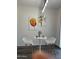 Bright breakfast nook with modern white table and chairs, complemented by vibrant floral artwork at 6421 S 23Rd Dr, Phoenix, AZ 85041