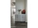 Clean and stylish hallway featuring extra cabinetry with a modern design, flowing into the living area at 6421 S 23Rd Dr, Phoenix, AZ 85041