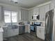 Modern kitchen featuring stainless steel appliances, gray cabinets, and quartz countertops at 6421 S 23Rd Dr, Phoenix, AZ 85041