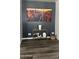 Modern decor highlights the living room, featuring gray accent wall, console table, and wood-look flooring at 6421 S 23Rd Dr, Phoenix, AZ 85041