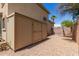Backyard with a storage shed, gravel ground cover, and a swing set at 6657 W Aurora Dr, Glendale, AZ 85308