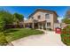 Large backyard featuring green lawn, covered patio, exterior elevation of home, and red playhouse at 6657 W Aurora Dr, Glendale, AZ 85308