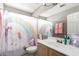 Charming bathroom with a unicorn and rainbow shower curtain, sink, and ample lighting at 6657 W Aurora Dr, Glendale, AZ 85308
