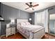 Cozy bedroom featuring a ceiling fan, natural light, and a charming, comfortable ambiance at 6657 W Aurora Dr, Glendale, AZ 85308