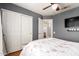 Comfortable bedroom features neutral wall paint, ceiling fan, and carpeted flooring for a cozy feel at 6657 W Aurora Dr, Glendale, AZ 85308
