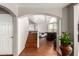 Inviting entryway with a wooden staircase leading to the upper level, and an open view to the living spaces at 6657 W Aurora Dr, Glendale, AZ 85308
