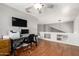Functional office space with desk, chair, and television, ideal for remote work at 6657 W Aurora Dr, Glendale, AZ 85308