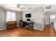 Functional office space with desk, chair, and television, ideal for remote work at 6657 W Aurora Dr, Glendale, AZ 85308
