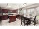Well-lit kitchen with an island, stainless steel appliances, granite countertops, and tiled flooring at 6657 W Aurora Dr, Glendale, AZ 85308