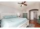 Comfortable main bedroom with a ceiling fan, and a doorway that reveals the adjoining bathroom, creating a retreat at 6657 W Aurora Dr, Glendale, AZ 85308