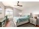 Sunlit main bedroom boasts a spacious layout, complemented by stylish furniture, and beautiful natural light at 6657 W Aurora Dr, Glendale, AZ 85308