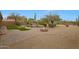 Stunning backyard oasis with a fire pit, water feature and a desert landscape at 6672 E Horned Owl Trl, Scottsdale, AZ 85266
