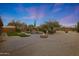 Stunning backyard oasis with a fire pit, water feature and a desert landscape at 6672 E Horned Owl Trl, Scottsdale, AZ 85266