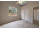 Bright bedroom with tile floors, ceiling fan, large window, and closet at 6672 E Horned Owl Trl, Scottsdale, AZ 85266