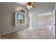 Well-lit bedroom featuring a ceiling fan, tile floors and large window with shutters at 6672 E Horned Owl Trl, Scottsdale, AZ 85266