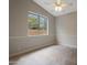 Bedroom with neutral colors, tile floors, a ceiling fan, and large window at 6672 E Horned Owl Trl, Scottsdale, AZ 85266