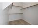 Walk-in closet with tile flooring, wood shelving, and ample space at 6672 E Horned Owl Trl, Scottsdale, AZ 85266