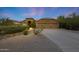 Exterior showcasing desert landscaping, a concrete driveway, and a two-car garage at 6672 E Horned Owl Trl, Scottsdale, AZ 85266