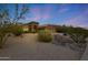 Charming exterior with manicured front yard and a circular driveway at 6672 E Horned Owl Trl, Scottsdale, AZ 85266