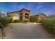 Charming single-story home with a tile roof, desert landscaping, and inviting entry way at 6672 E Horned Owl Trl, Scottsdale, AZ 85266