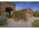 Exterior view featuring manicured landscaping, a two-car garage, and well-lit entryway at 6672 E Horned Owl Trl, Scottsdale, AZ 85266