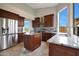 Open kitchen featuring stainless steel appliances, dark wood cabinets, and marble countertops at 6672 E Horned Owl Trl, Scottsdale, AZ 85266