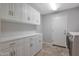 Laundry room with washer, dryer, overhead cabinets and a countertop at 6672 E Horned Owl Trl, Scottsdale, AZ 85266