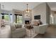 Staged living room with backyard access and fireplace, creating a cozy and inviting atmosphere at 6672 E Horned Owl Trl, Scottsdale, AZ 85266