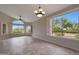 Spacious room with modern ceiling fan, expansive windows providing serene views, and tiled floor at 6672 E Horned Owl Trl, Scottsdale, AZ 85266