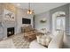 Staged living room featuring a stone fireplace, comfortable seating, and neutral decor at 6672 E Horned Owl Trl, Scottsdale, AZ 85266