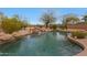 Backyard pool featuring a rock waterfall and desert landscaping at 6672 E Horned Owl Trl, Scottsdale, AZ 85266