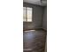 A modest bedroom featuring wood-look floors, neutral walls, and a window for natural light at 6722 W Shannon St, Chandler, AZ 85226