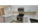 Well-lit kitchen with white cabinets, quartz countertops, and stainless steel appliances at 6722 W Shannon St, Chandler, AZ 85226