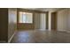 Spacious living room with wood-look flooring, neutral walls, and sliding glass door at 6722 W Shannon St, Chandler, AZ 85226