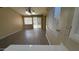 Bright living room with wood floors, sliding glass doors to the backyard, and neutral paint at 6722 W Shannon St, Chandler, AZ 85226