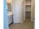 Neutral bathroom with a single sink vanity and walk-in closet with shelving at 7209 E Blissful Breeze Ln, San Tan Valley, AZ 85143