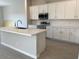 Modern kitchen featuring an island, stainless steel appliances, and white cabinets at 7209 E Blissful Breeze Ln, San Tan Valley, AZ 85143