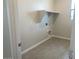 Functional laundry room with tile floor and built-in shelving for storage solutions at 7209 E Blissful Breeze Ln, San Tan Valley, AZ 85143