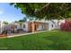 Spacious backyard featuring a covered patio, outdoor sauna, and a basketball hoop at 728 E State Ave, Phoenix, AZ 85020