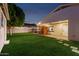 Spacious backyard featuring lush lawn, sauna, and outdoor lights perfect for relaxation and entertaining at 728 E State Ave, Phoenix, AZ 85020